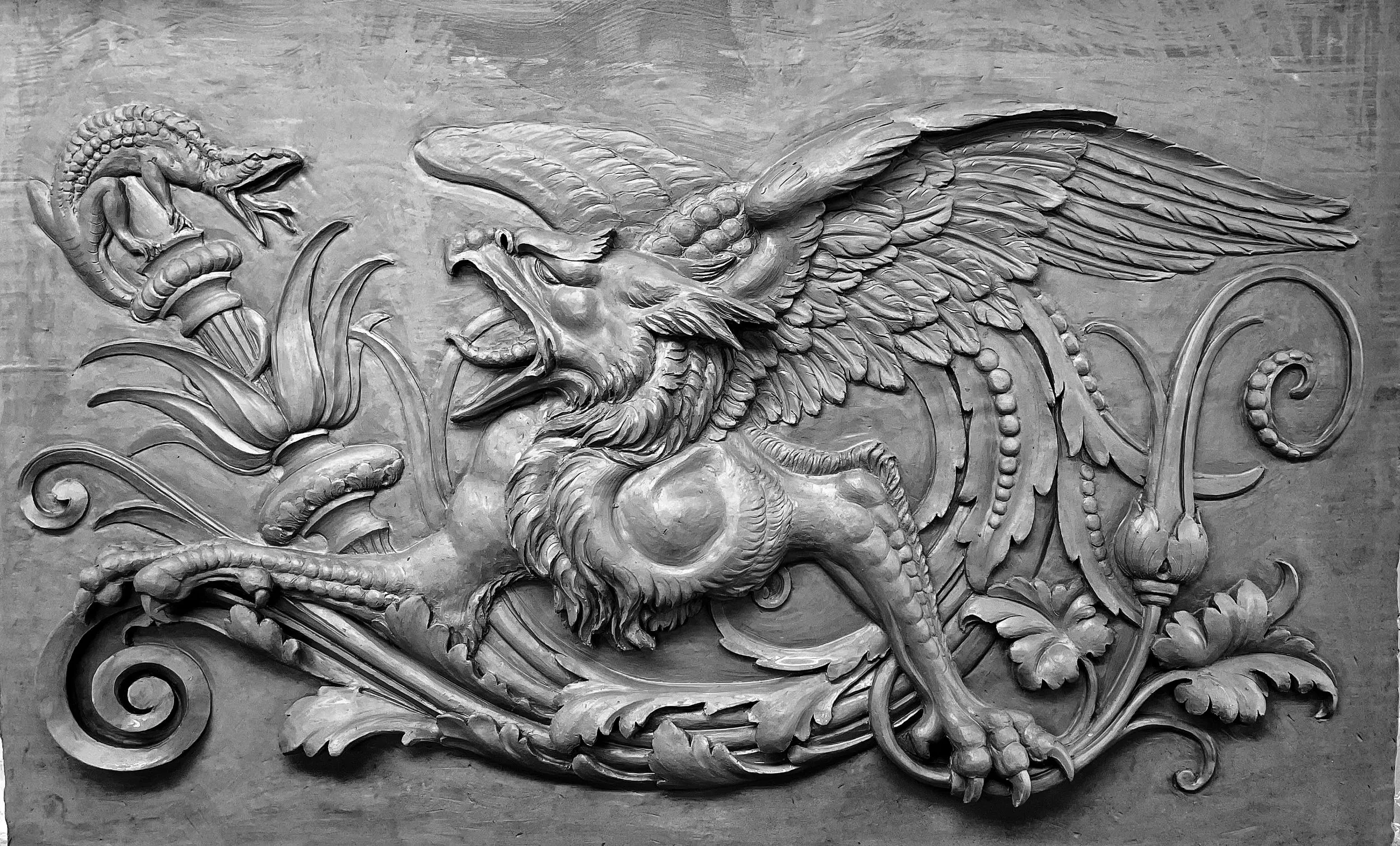 Clay model relief of a grotesque winged griffin among acanthus scrolls, with a lizard on a torch, 2022